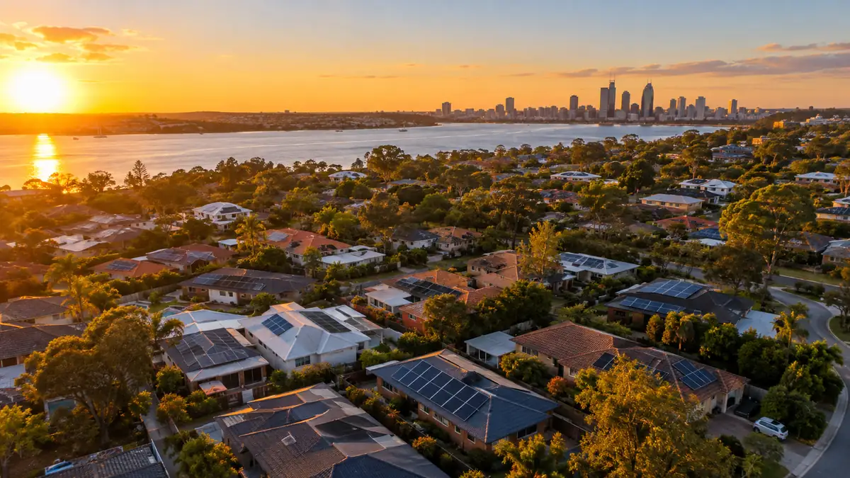 Aerial view of Perth suburbs with rooftop solar panels at golden hour